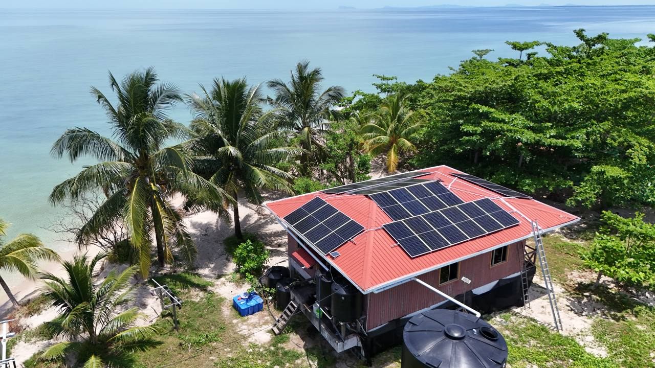 Solar panels on a coastal rooftop in Sabah
